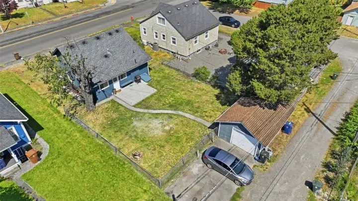 Ample uncovered parking for 2-3 cars with alley access and a 1-car garage.