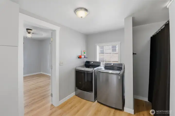 Dedicated laundry area — Convenient interior laundry space with full-size washer and dryer and a sunny window.