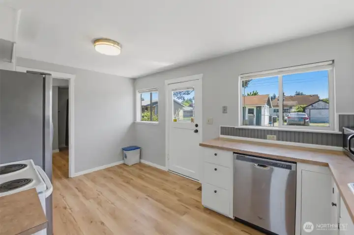 Bright eat-in kitchen — Sunny dining nook with backyard views and direct outdoor access.