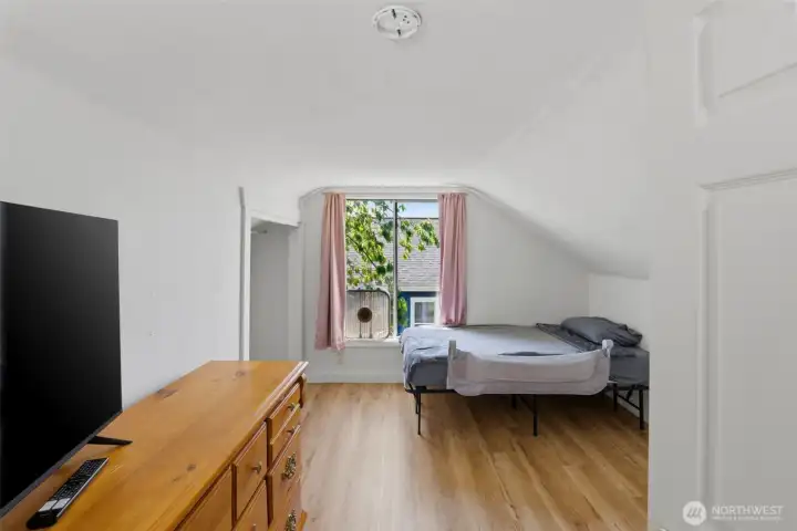 Versatile upper bedroom — Bright space ideal as a bedroom, nursery, or flex room.