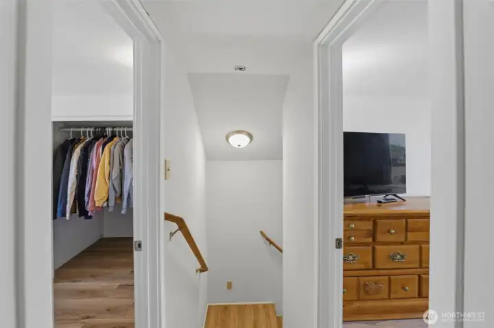 Upper-level landing — Thoughtful upstairs layout connecting the bedrooms with built-in closet storage.