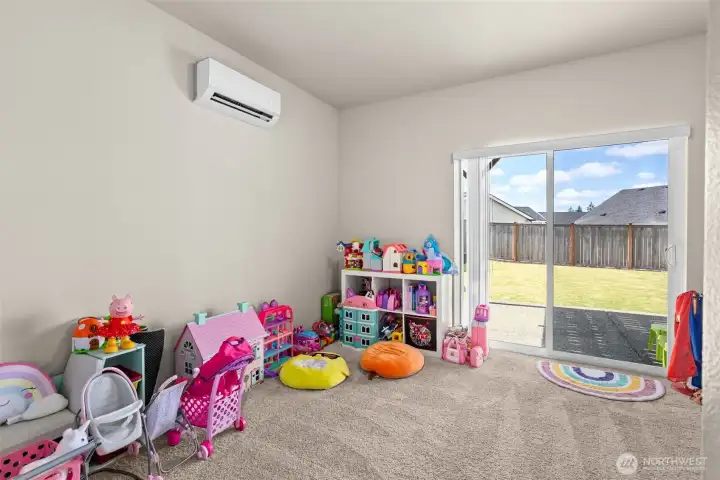 Downstairs bedroom leads with access to the fenced backyard space, plus a dual mini-split.