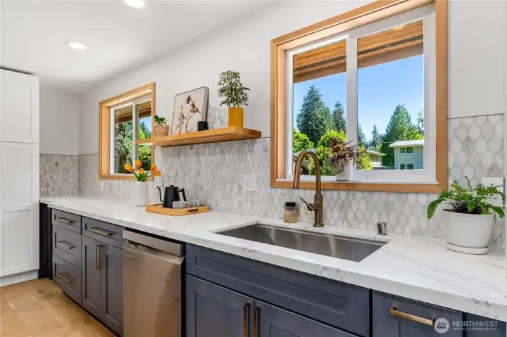 Large kitchen sink and counter with custom tile backsplash