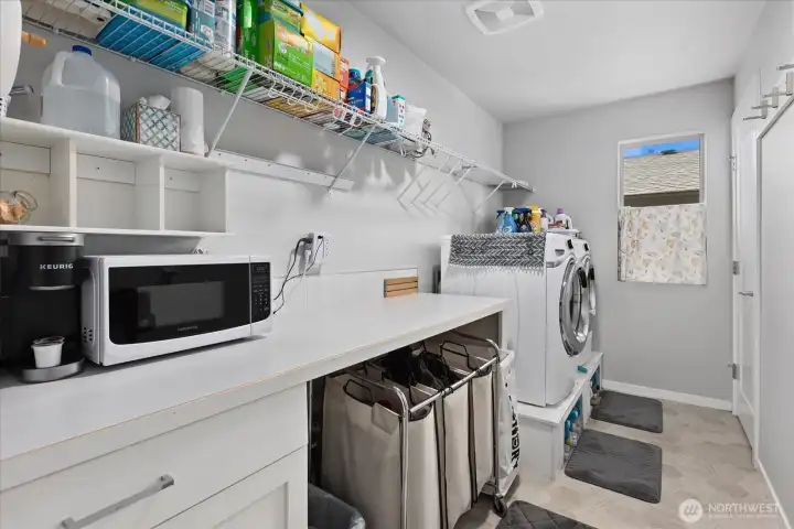Large Laundry room with storage. Door on right is furnace room.