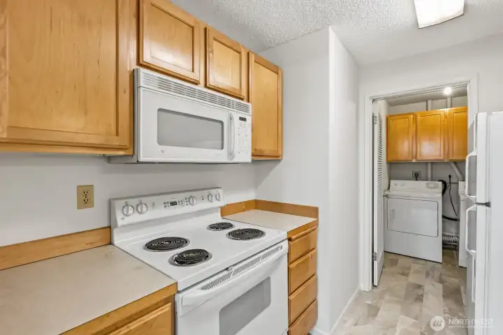 All white appliances blend nicely with the wood cabinets. All white appliances blend nicely with the wood cabinets.
