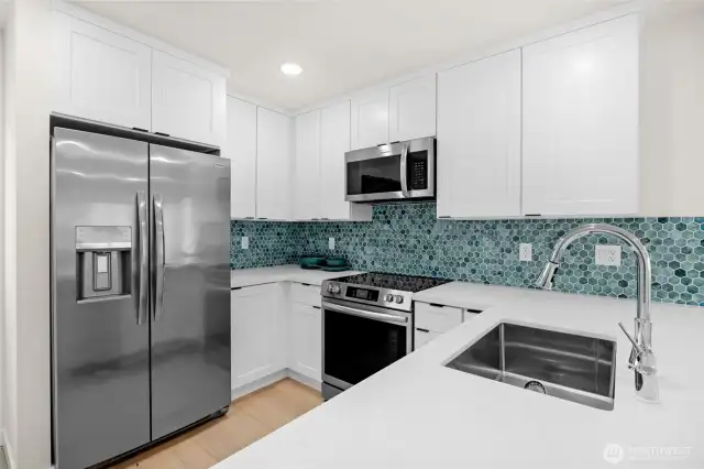 Beautiful quartz countertop and tile backsplash. All appliances included.