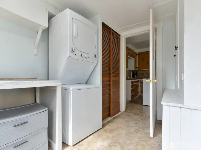 Entry into utility room.  Folding table to left, pantry to right, stacking gas laundry center stays