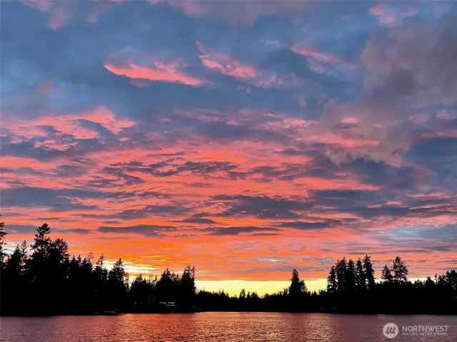 Sunset reflecting off water below and clouds above