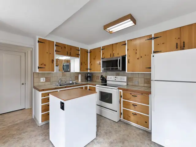 Kitchen features pine cabinets