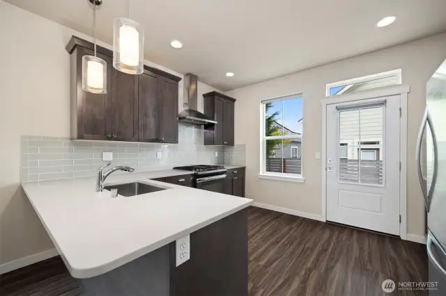 There is an eating bar for 4 people at the kitchen and so much room with all the cabinets and pantry. The counters are quartz and a nice neutral color.