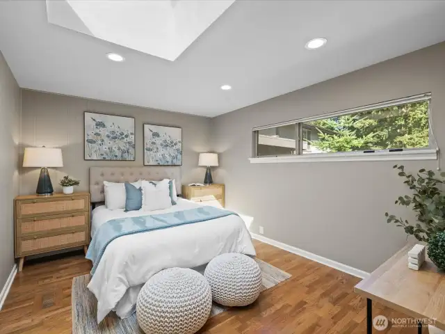 Primary bedroom has skylight that opens to allow fresh air, and is screened.
