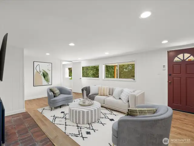 Lower level family room with doorway to backyard and covered patio. Virtually staged.