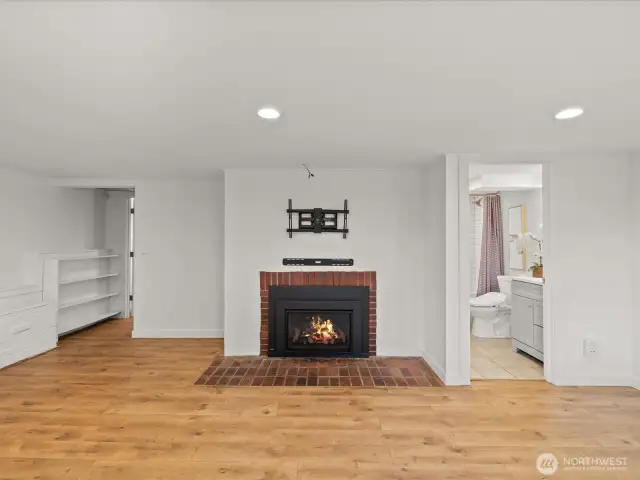 Lower level family room natural gas fireplace, shown un-staged.
