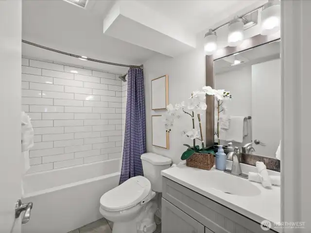 Lower level full bathroom with deep tub and shower head.