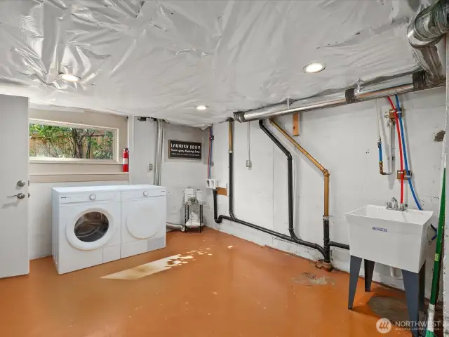 Virtually staged utility room on lower level with utility sink