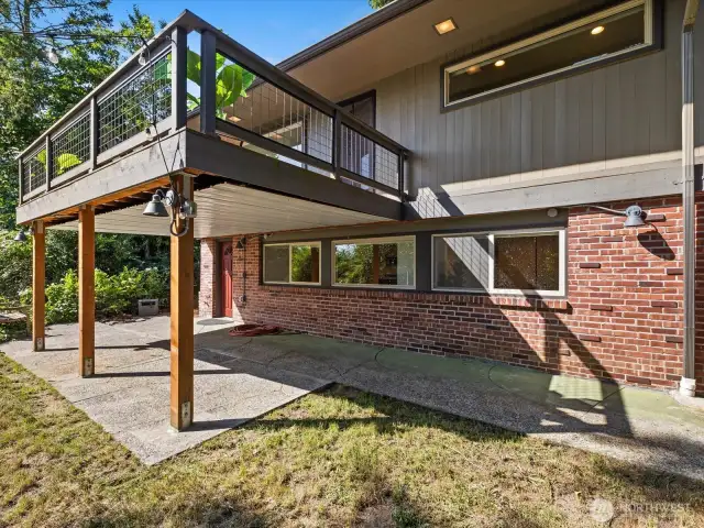 Covered back yard patio and view of main floor trex deck.