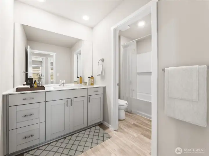 Hall bathroom with convenience of second door for privacy to toilet and tub/shower. Photo is representational. Actual home is under construction. Colors, materials, and features may vary. See site agent for details.