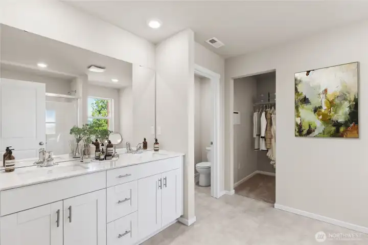 Primary bathroom with double vanity and quartz countertops. Photo is representational. Actual home is under construction. Colors, materials, and features may vary. See site agent for details.