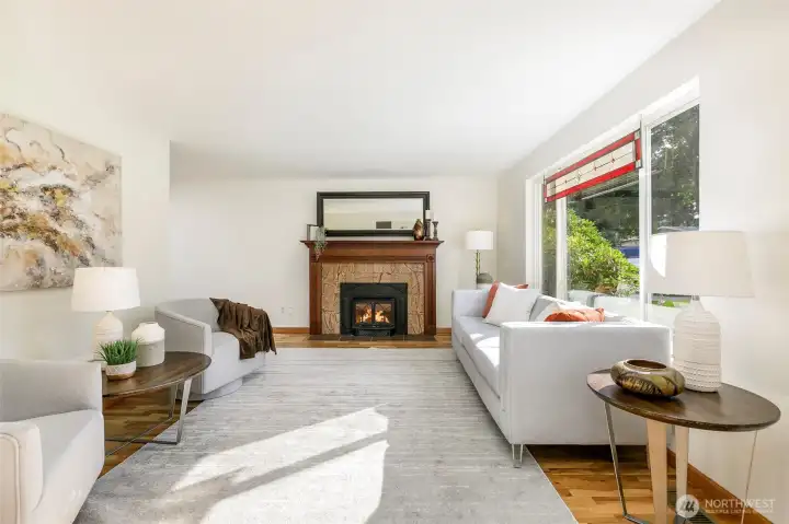Step inside to sunny living room w/ Jotul woodstove to keep you cozy all winter. Custom marble face & mantel centers you while you relax