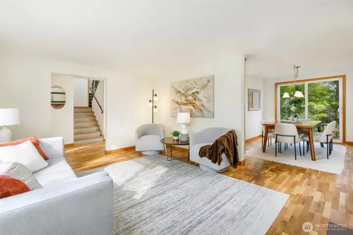 Glimpse at the unique side-oriented staircase & dining room from living area
