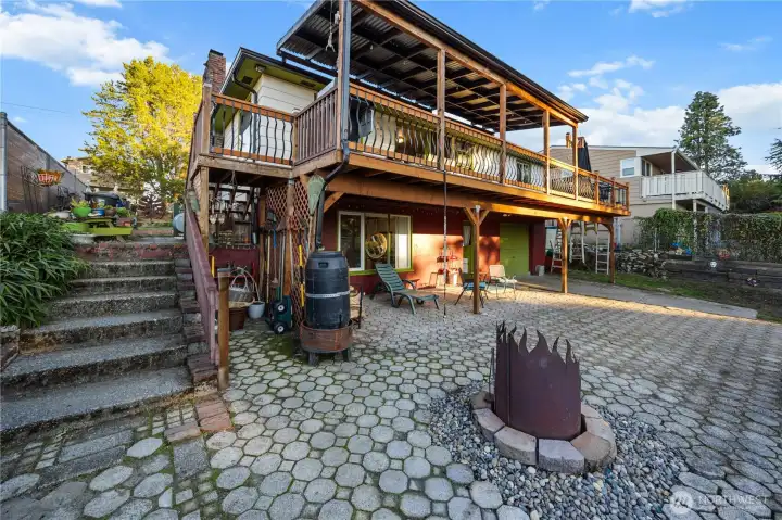 Covered deck above, covered patio below, and plenty of open air space.  This is a really large yard, full of fun and spirit.
