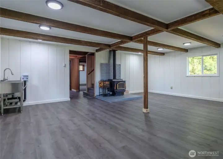 Open living area with woodstove and laundry hook ups