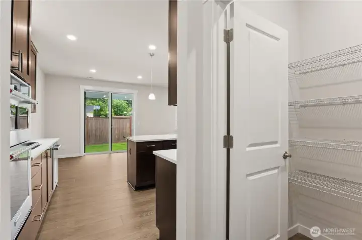 Large walk-in pantry and mud room area as you enter the home from your 2-car garage. Actual home is under construction and materials, colors, and finishes will vary. See site agent for details.