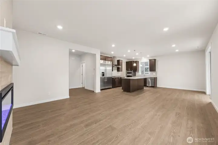 Overlooking at the kitchen from the great room. Actual home is under construction and materials, colors, and finishes will vary. See site agent for details.