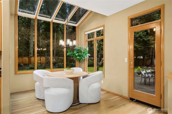 Sunlit breakfast nook ideally positioned between the kitchen and family room, with direct access to the backyard