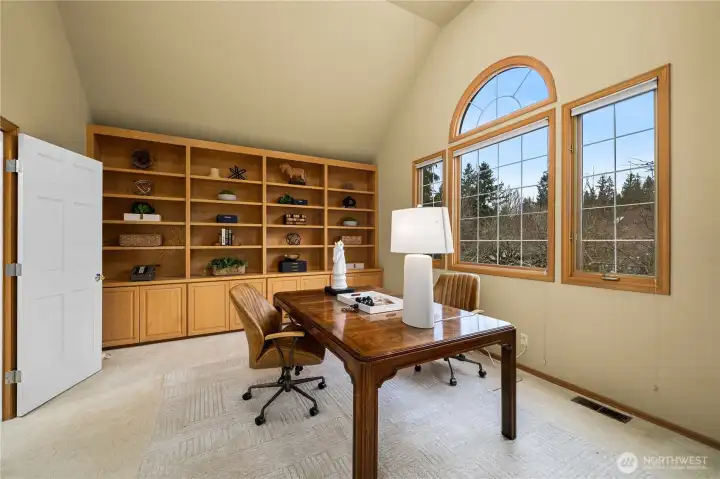 Expansive office featuring custom built-ins, offering flexibility as a bonus or media room