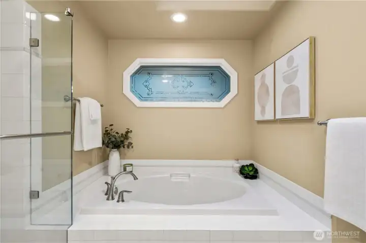 Spa-inspired primary bath with privacy glass, blending natural light with enhanced privacy