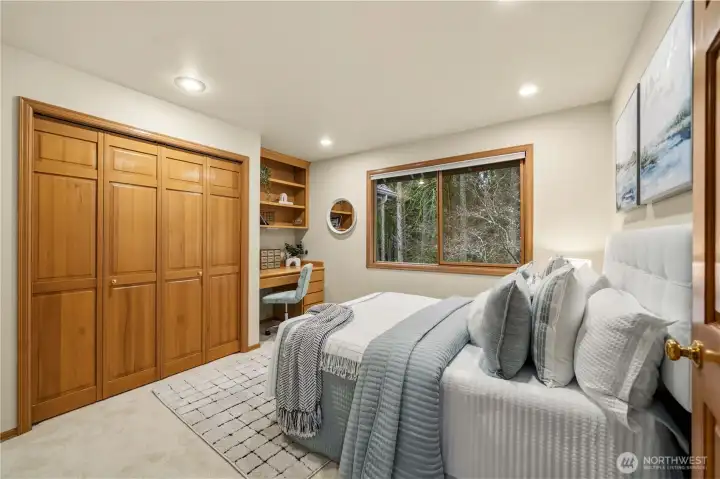 Light-filled upstairs bedroom with a built-in study desk, offering a functional and versatile space