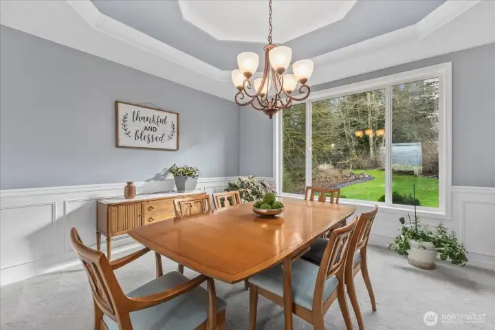 Formal Dining room overlooking the lush backyard. This room represents the true wall color thru house