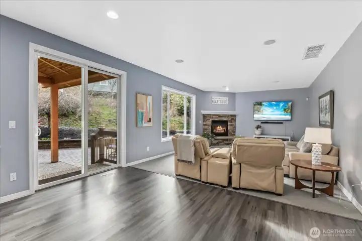 Extra large family room with built in speakers, gas fireplace and door to the covered patio and Backyard