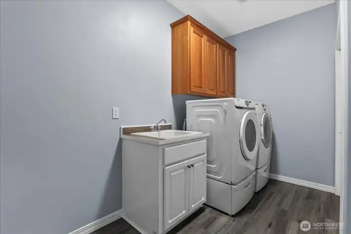 Extra large main floor laundry with utility sink and closet