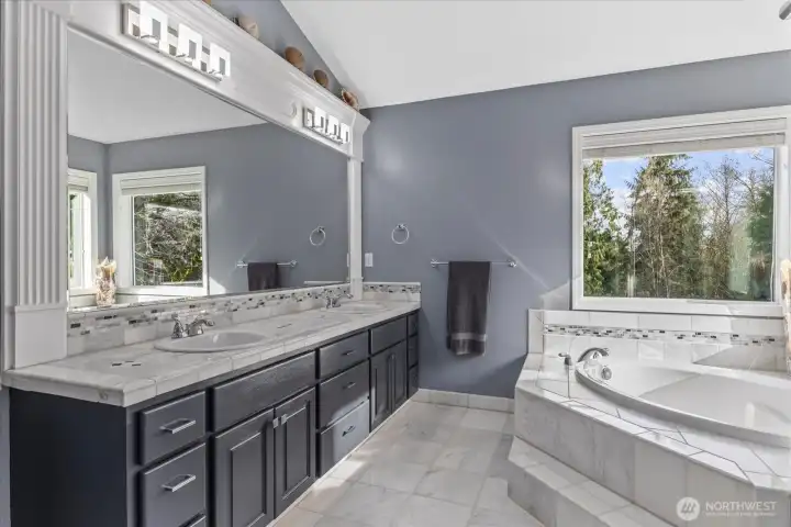 Primary suite, luxurious bathroom complete with marble floors