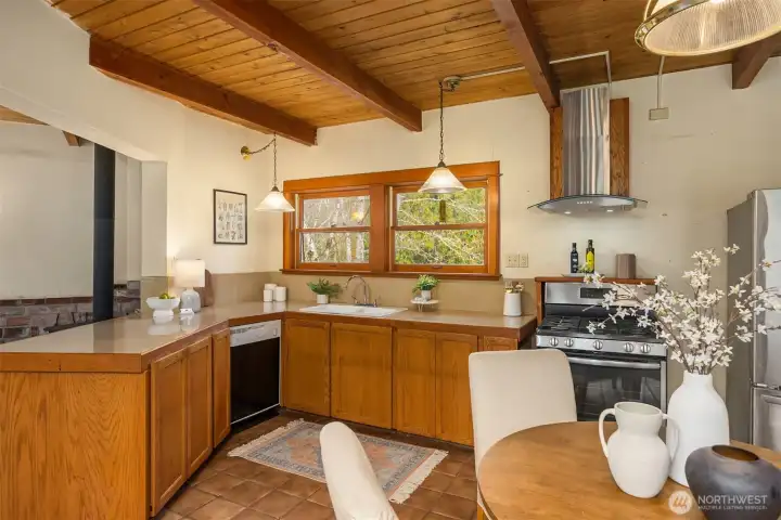The kitchen offers stainless appliances including a propane range.
