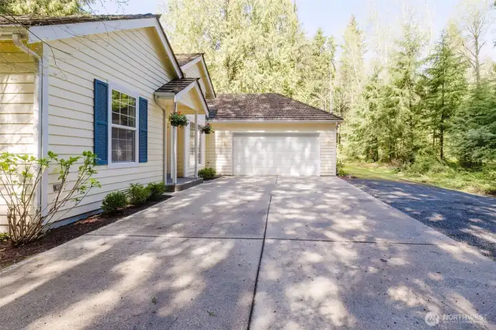 Two car garage and large parking pad