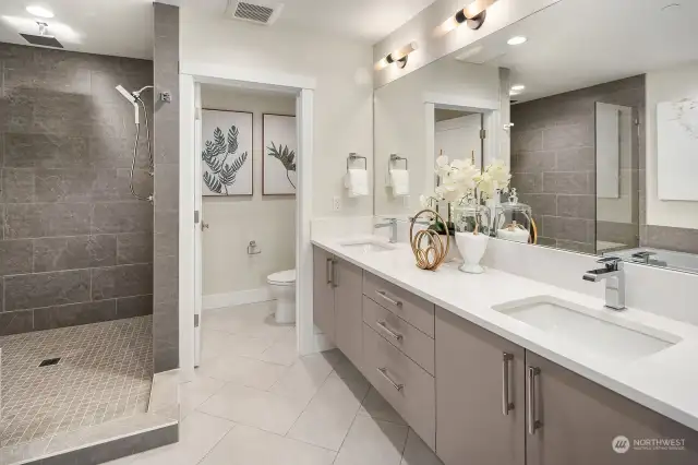 Well-appointed 5-piece primary bath with heated floors, Delta Ara fixtures and quartz countertops.