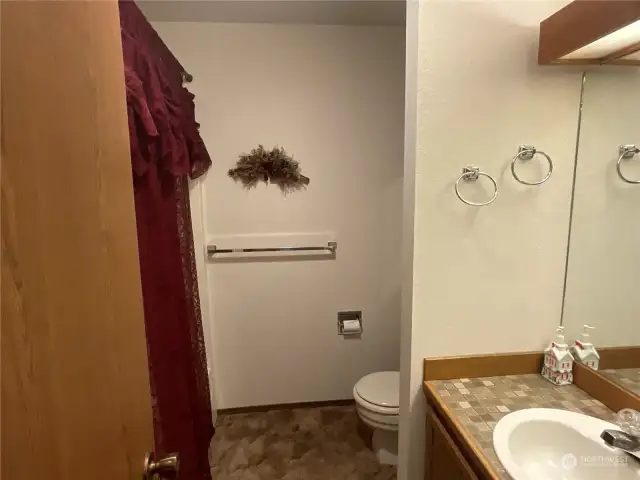 Primary bathroom has a tub with a shower.