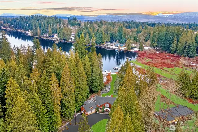 Nestled on the serene shores of Flowing Lake, this expansive estate boasts 30 feet of private sandy beach and a newer dock, perfect for enjoying the water.