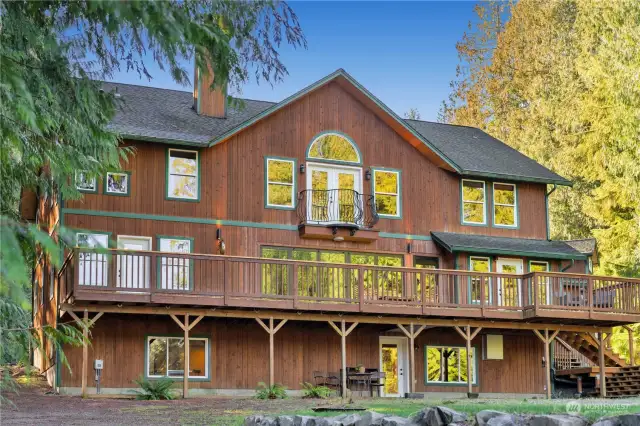 Sprawling deck seamlessly extends the living space outdoors, making it the perfect place for hosting gatherings, dining alfresco, or simply soaking in the stunning lake views.