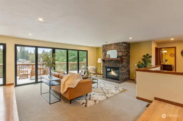 A grand stone fireplace serves as the focal point, creating a cozy ambiance for gathering with family and friends.