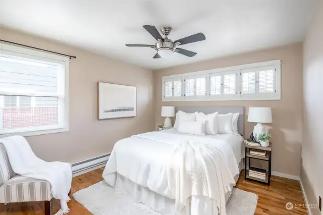 The primary bedroom is on the main floor towards the front of the home. Such a pretty set of windows with shutters.