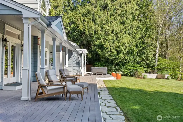 Composite deck overlooks the back yard, hot tub included
