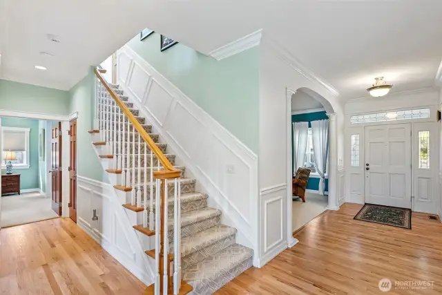 Gracious front entry hall with newly refinished hardwood floors