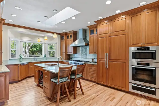 Updated gourmet kitchen with custom cabinetry and paneled appliances