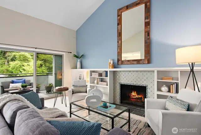 Living room with cathedral ceiling, built-in shelving and cozy wood fireplace