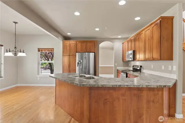 Kitchen with breakfast nook leading to back patio