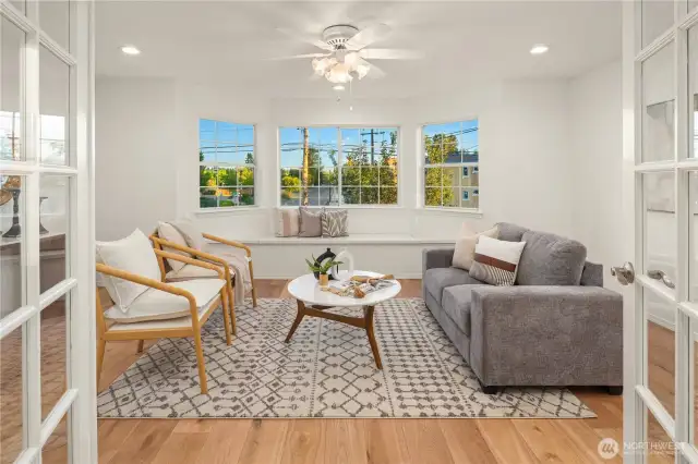 Primary suite with large bay windows plus built-in nook seating with storage